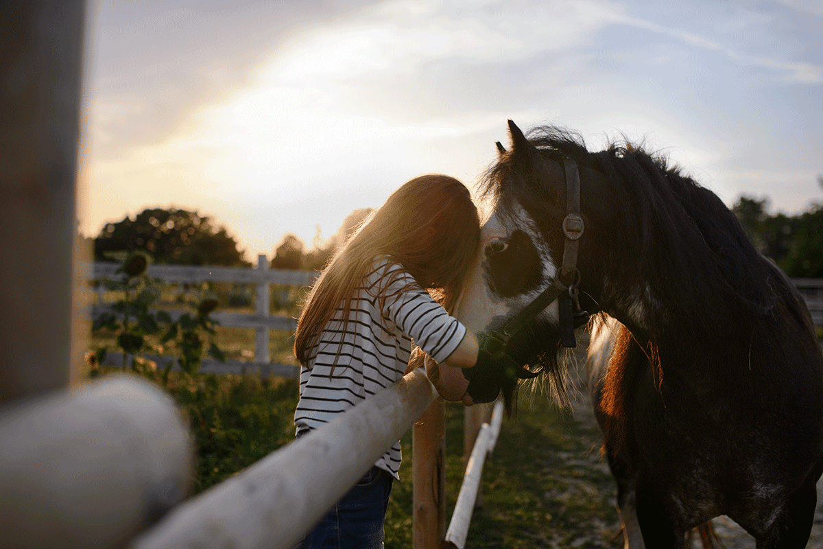 Person with horse, wondering, "What is equine therapy?"