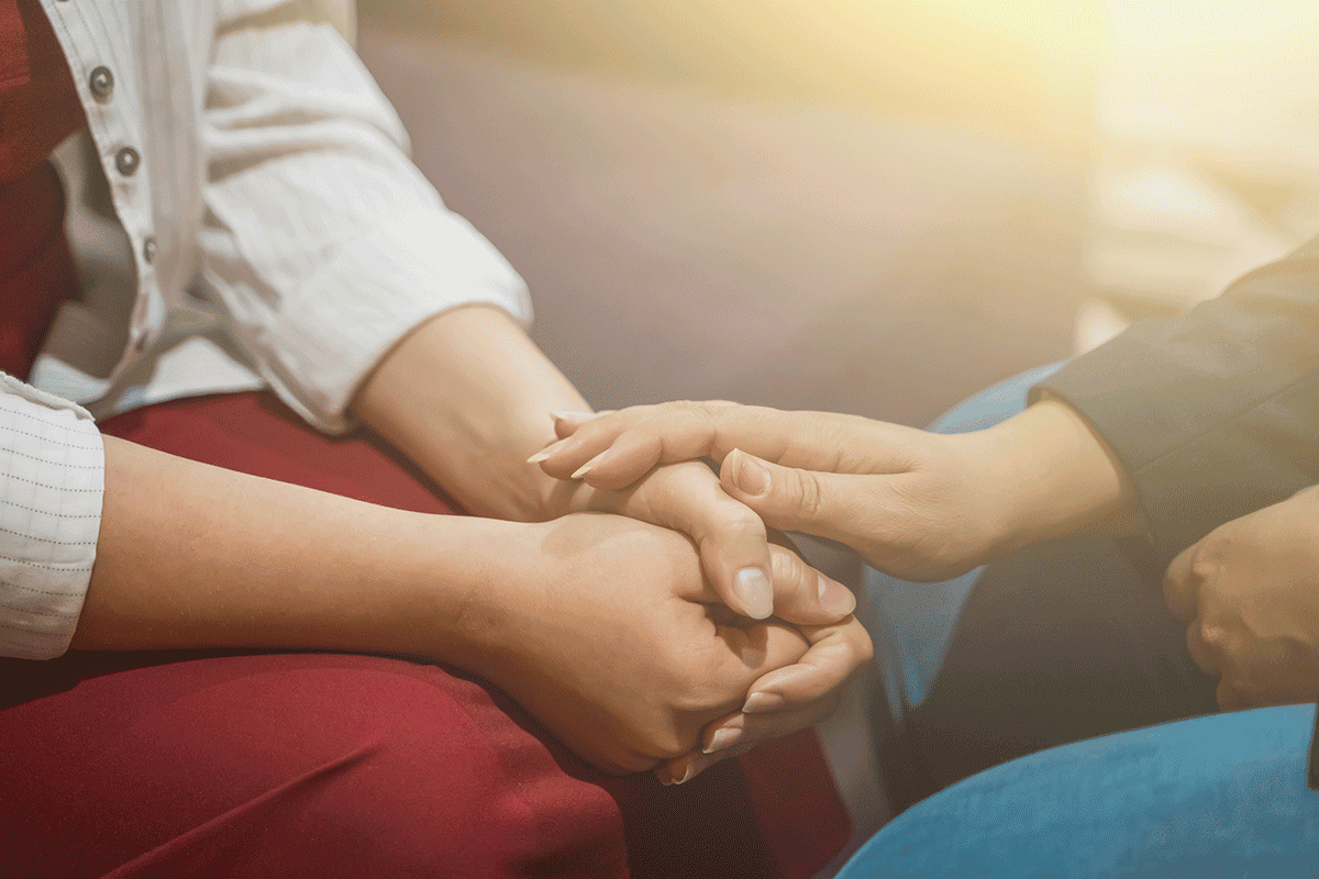 Hands of two people talking about the best way to treat trauma