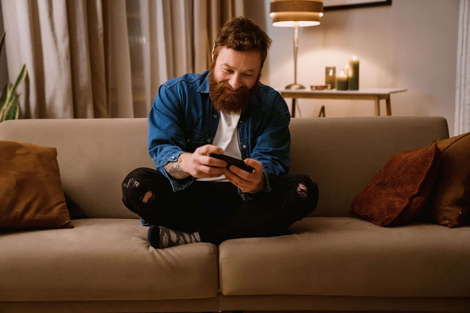 Man thinking about process addiction signs while sitting on a couch